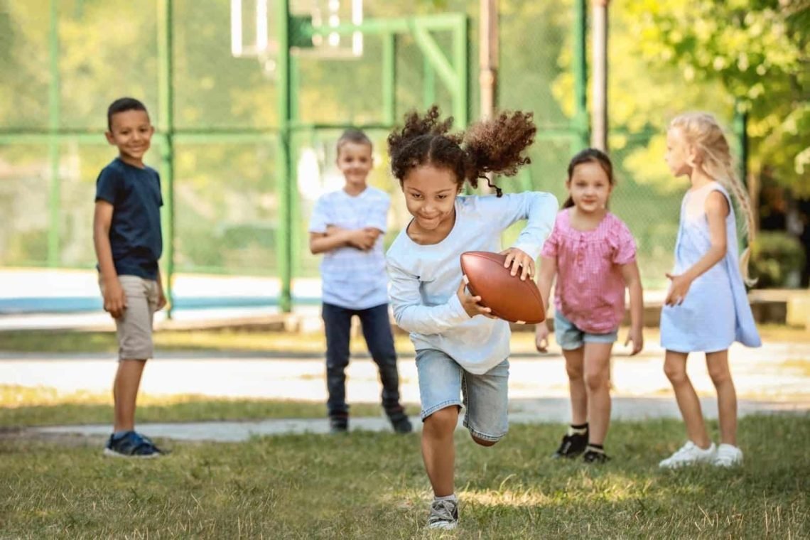 girl-running-with-football